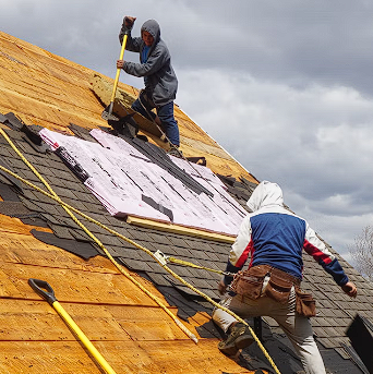 Two men on roofs doing roof jobs