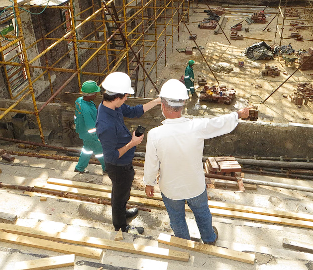 Two people speaking on a construction site