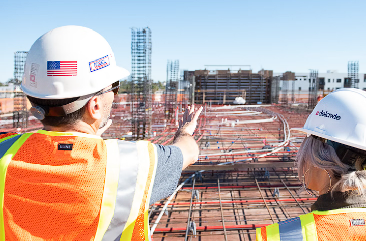 Two people speaking on a construction site