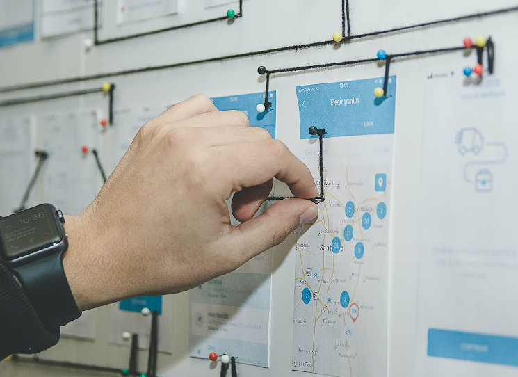 Man pinning something on a wall board