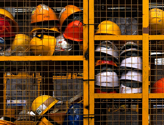 A rack filled with lots of yellow helmets