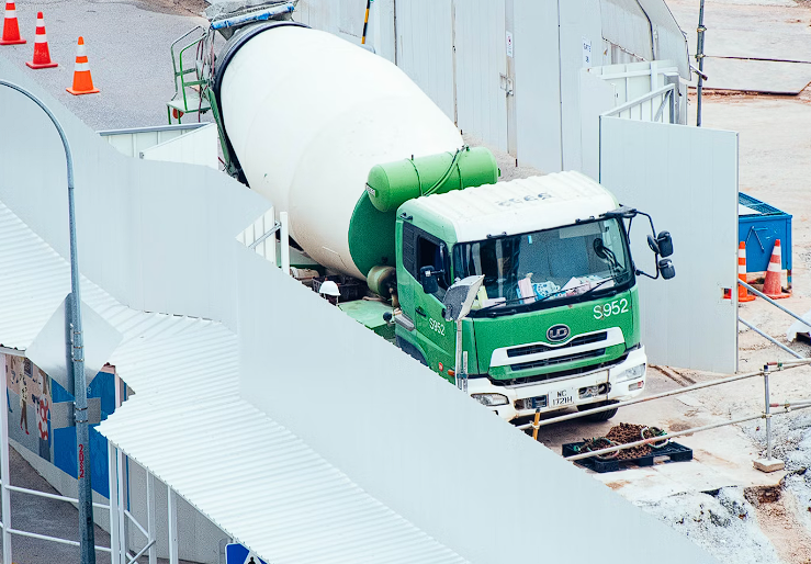 Green and white mixer on a construction site